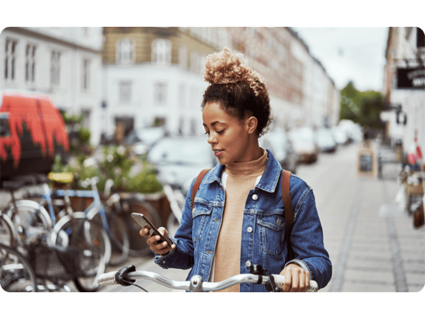 woman using her mobile by her bike