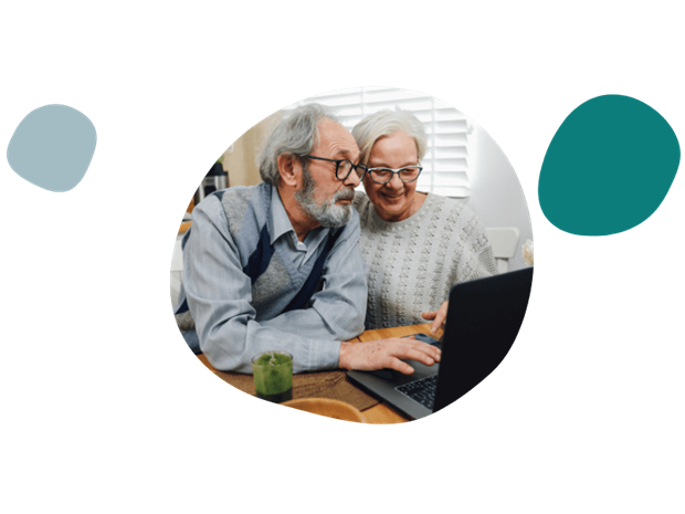 elderly couple using a laptop