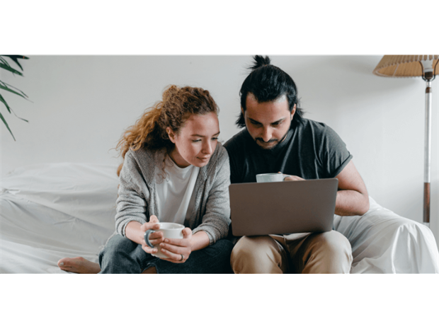 young couple using their computer at home
