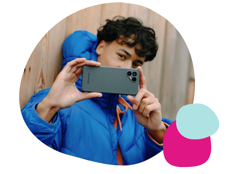 young man using a fairphone to take a picture