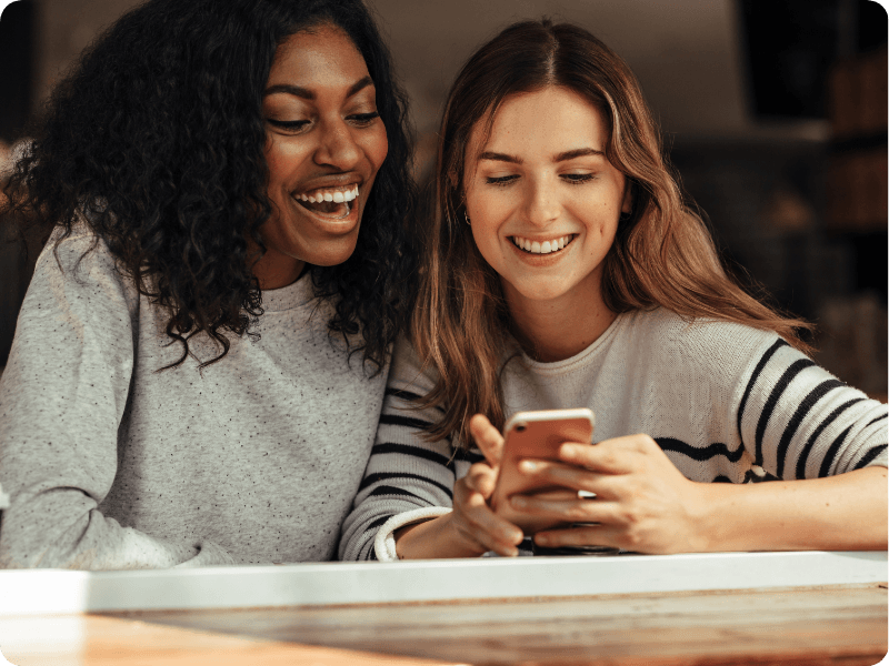 two friends using a mobile together