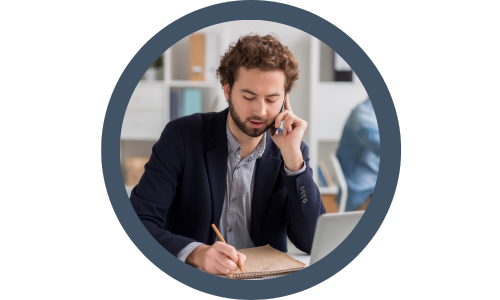 man on the phone making notes