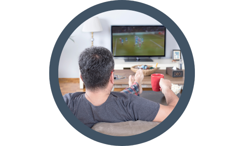 man sat on his sofa watching sports on tv