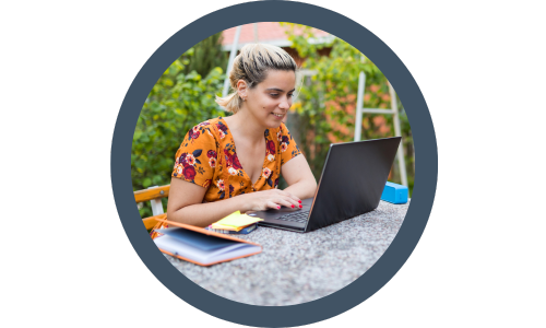 woman sat outside using her laptop