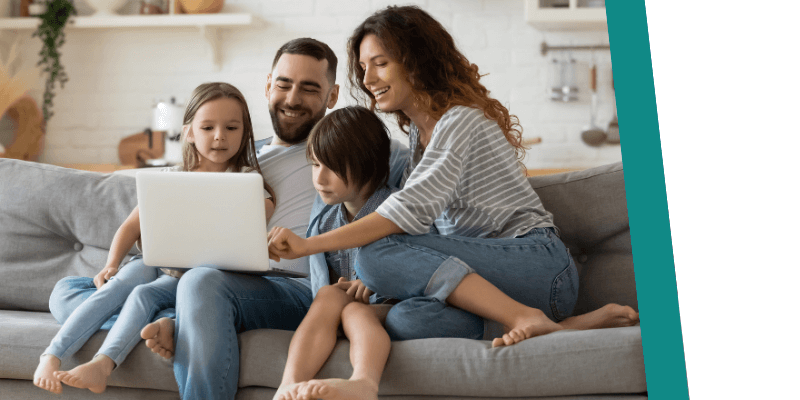family sat around their laptop