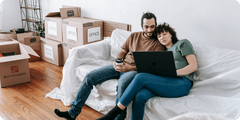 young couple using their laptop to check broadband availability