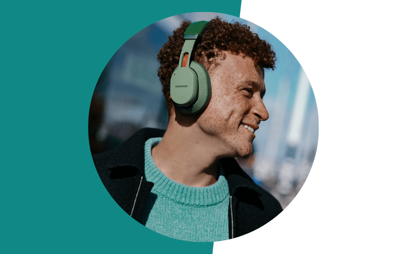 man wearing green Fairbuds XL headphones