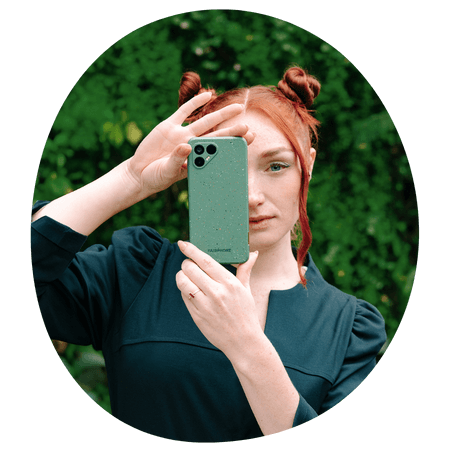 woman holding a green Fairphone 4 up to her face