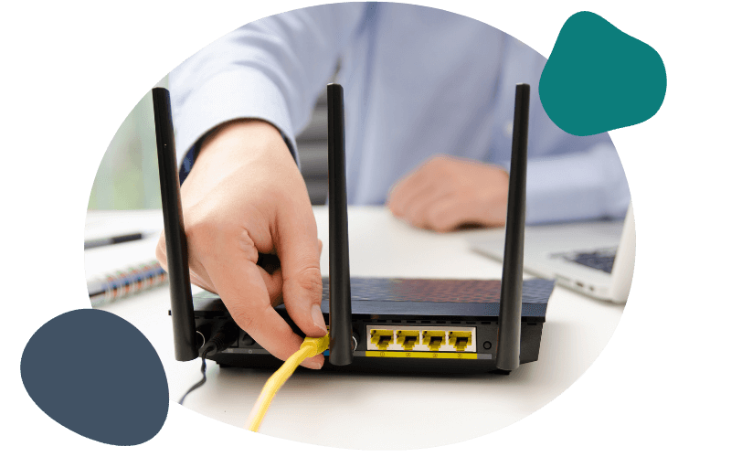 person plugging in their LAN cable into the router