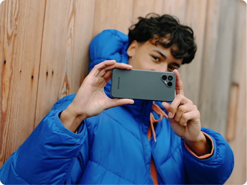 young man using a fairphone to take a picture