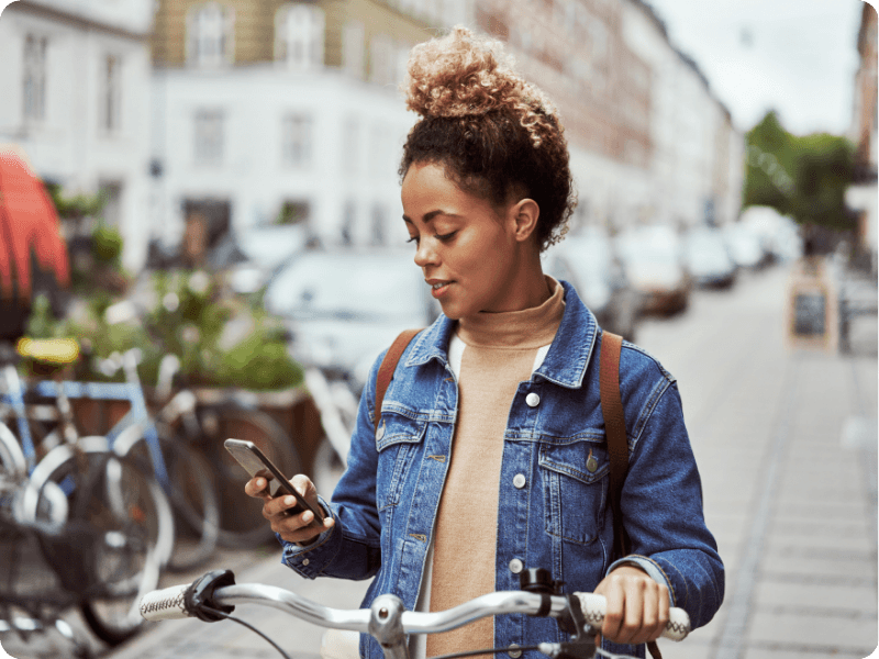 young woman using her mobile outside