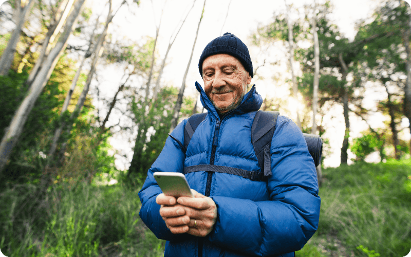 elderly man using his mobile outside