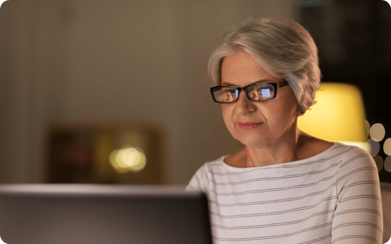 elderly woman using her computer