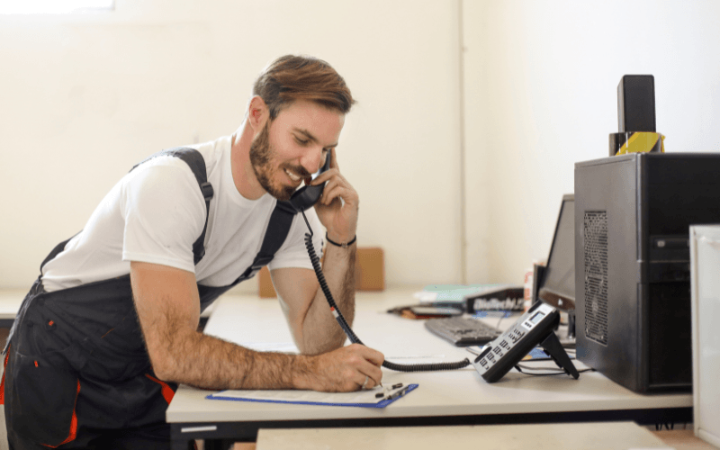 man on the phone whilst making notes