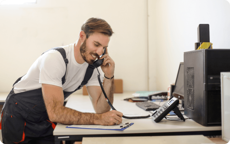 man on the phone whilst making notes