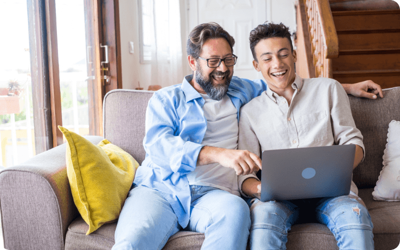 Father & Son using a laptop together