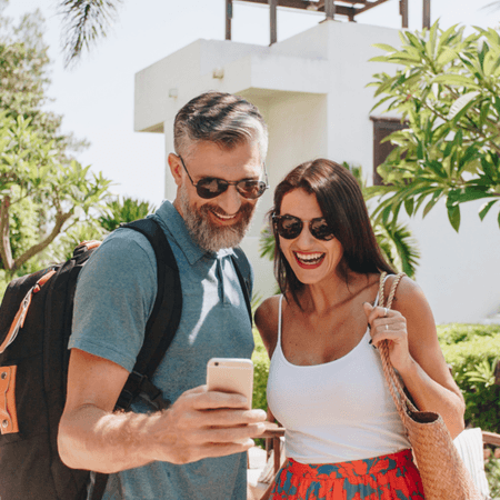 couple using their phone on holiday