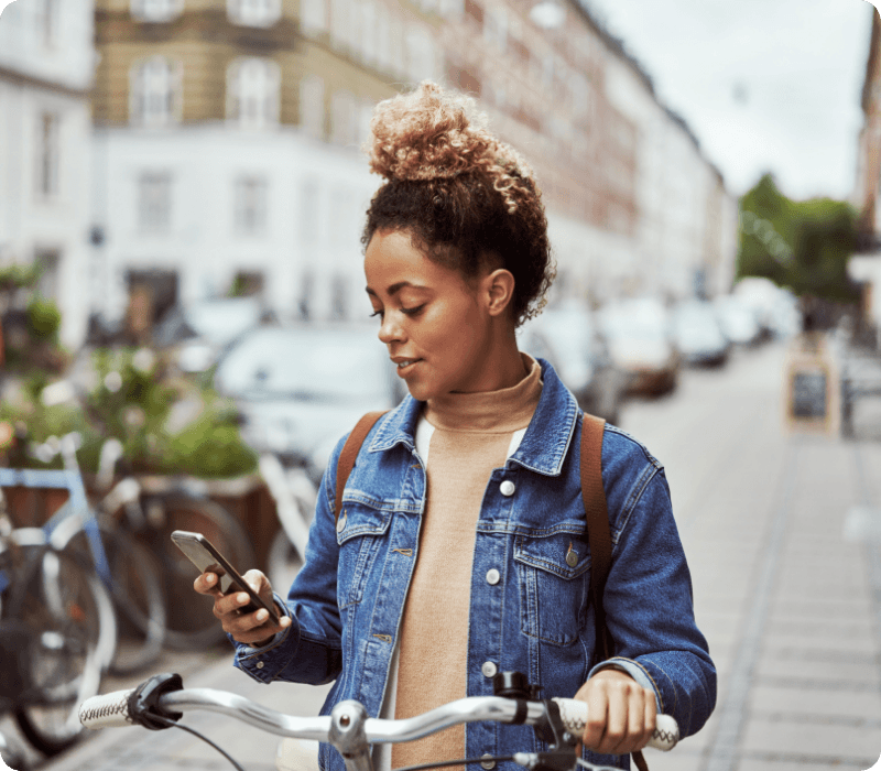 woman using her mobile with her bicycle