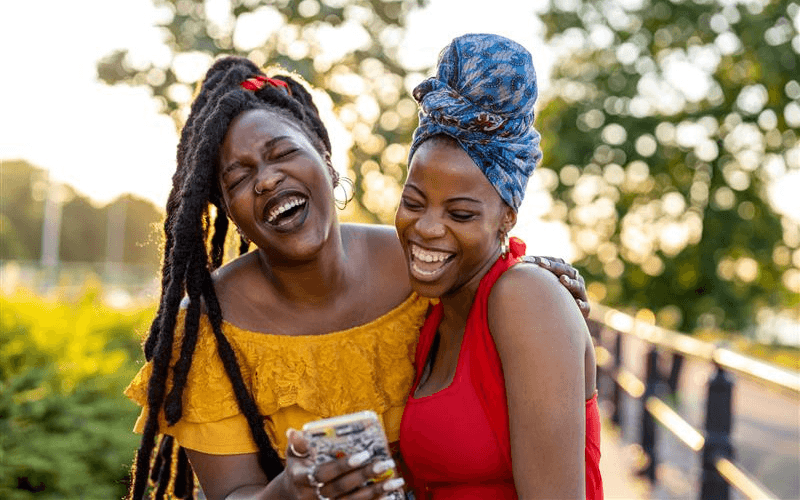 two friends laughing on the phone together