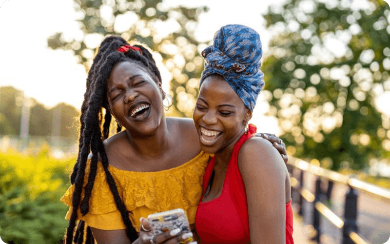 two friends laughing on the phone together