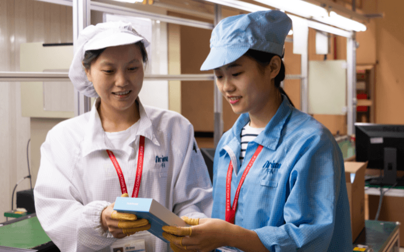 two workers holding a fairphone