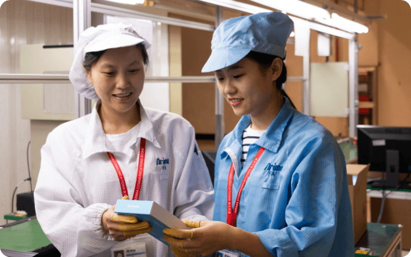 two workers holding a fairphone
