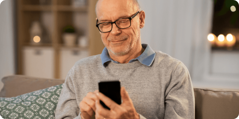 elderly man using his phone