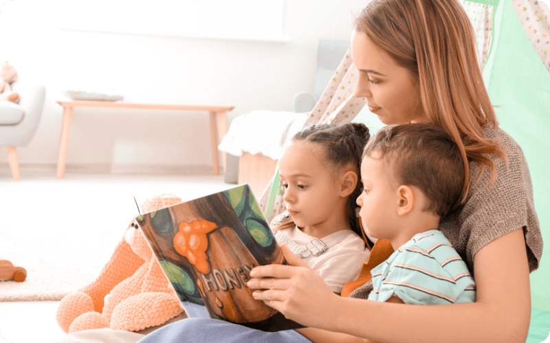 Young family reading a book together