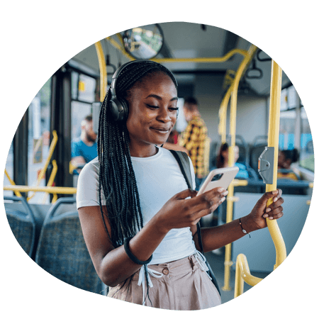 young girl using her iPhone on a bus