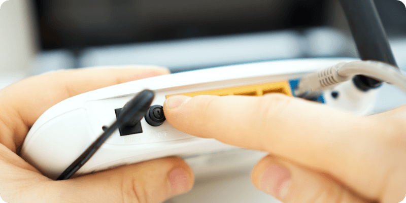 person switching their WPS button 