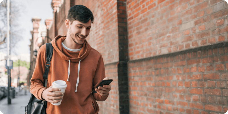 man walking and using his mobile