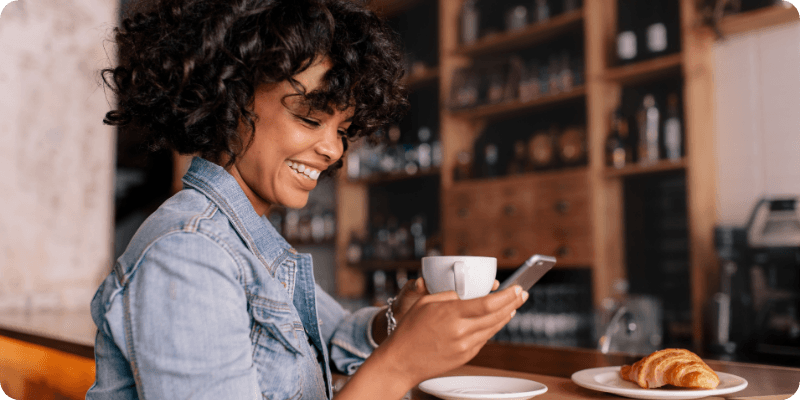 woman using her phone in a coffee shop