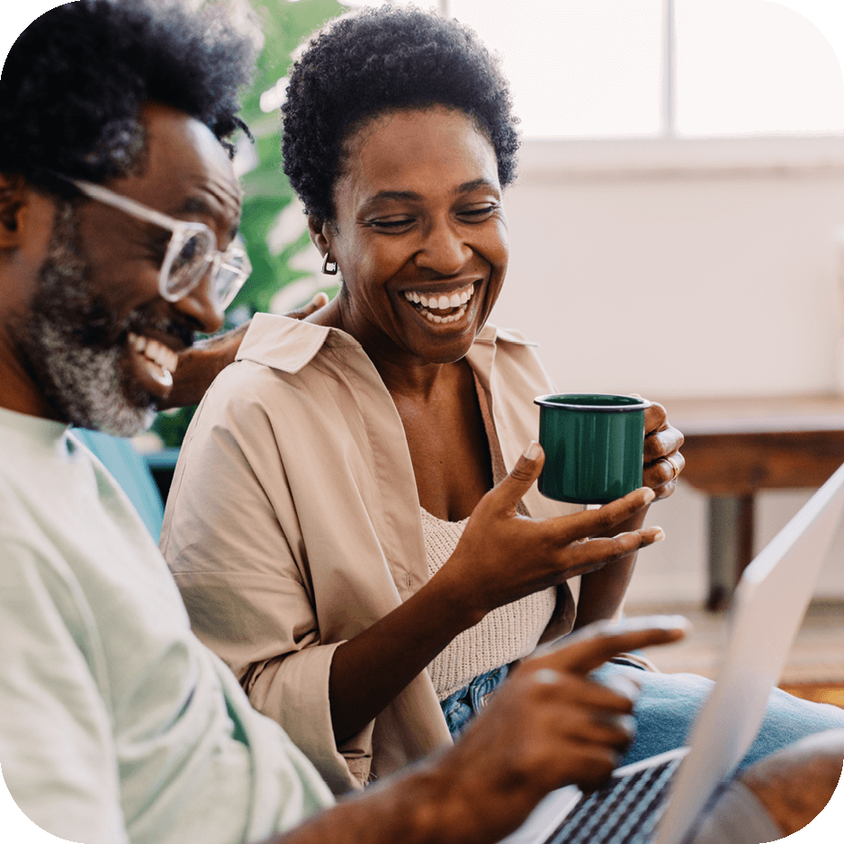 young couple looking on their laptop together 