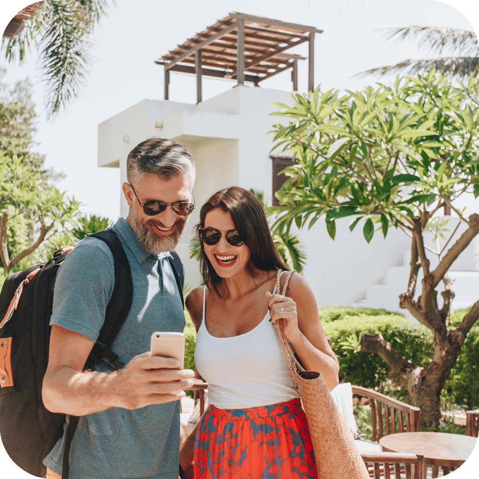 Couple using their mobile on holiday