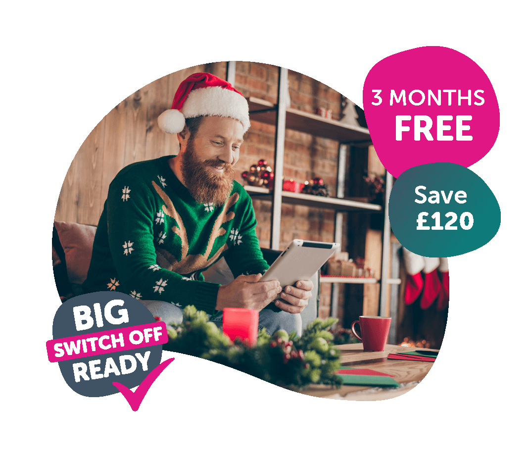 man wearing a santa hat using his tablet