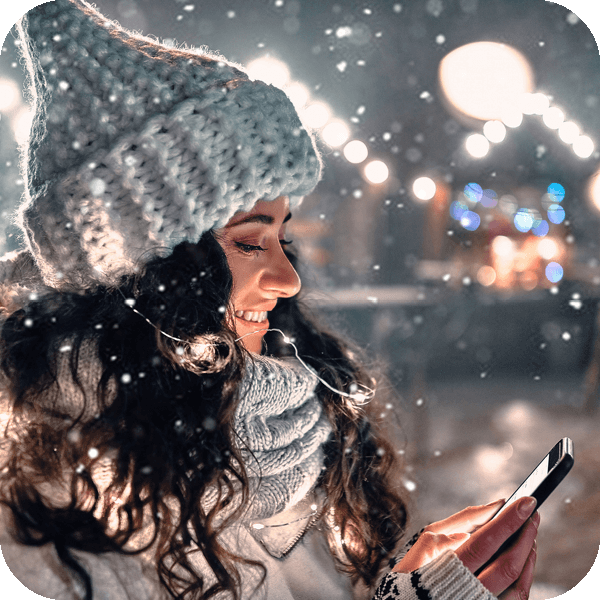 woman using her mobile in the snow