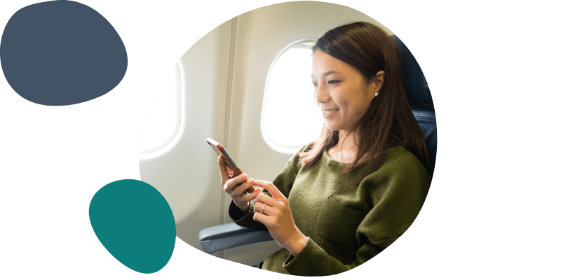 woman using her mobile on a plane