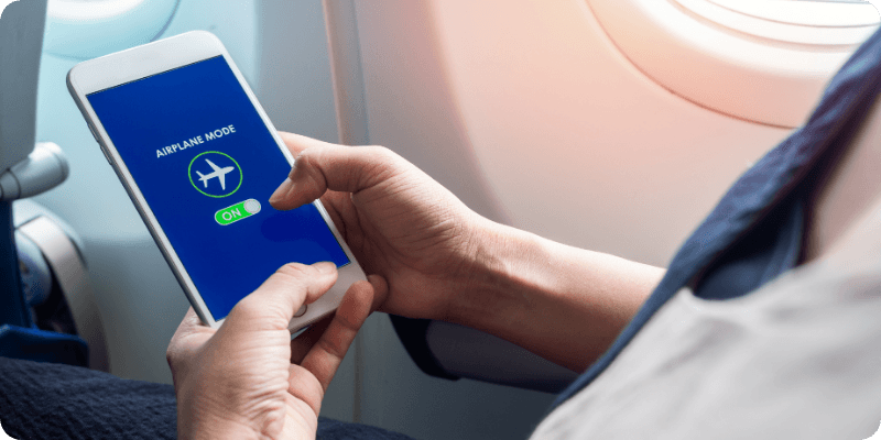 person turning airplane mode on their mobile