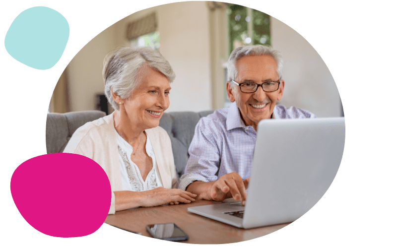 elderly couple using a laptop