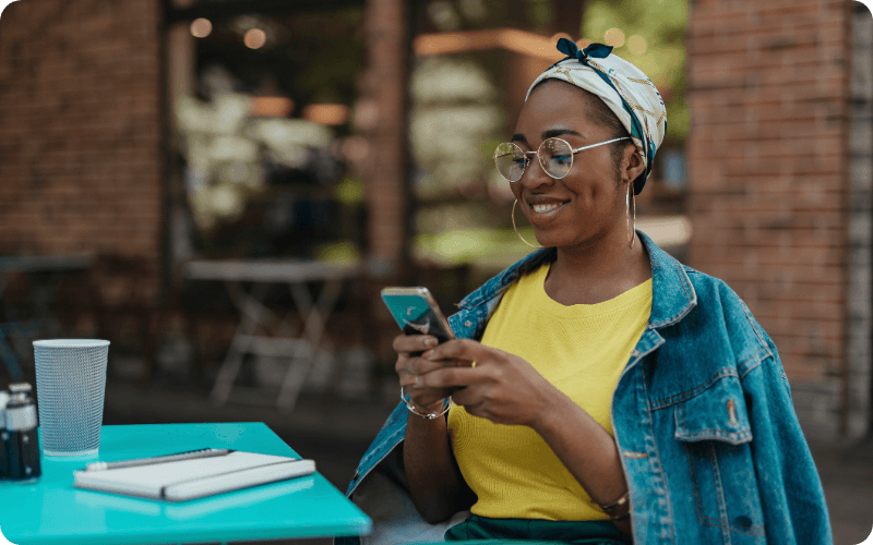 young woman using her mobile outside