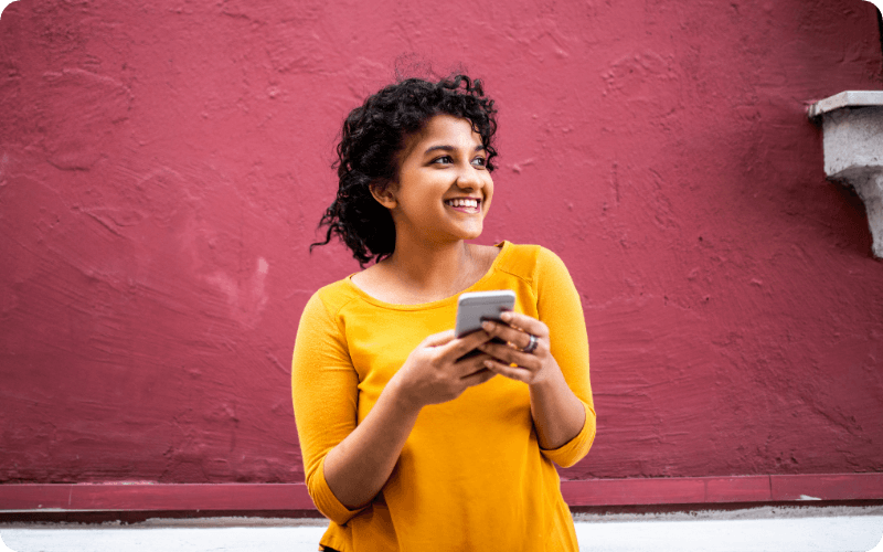 young woman using her mobile outdoors