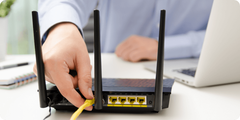 person unplugging their ethernet cable