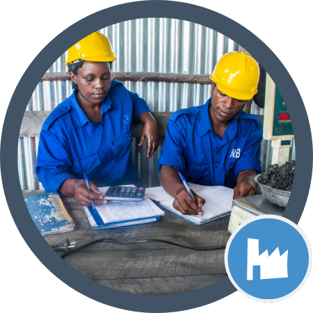 Two workers wearing hardhats working on a document