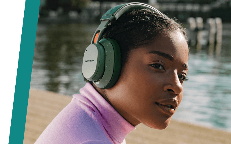 woman wearing green Fairbuds XL headphones