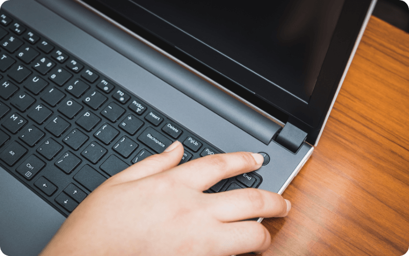 person turning off their laptop