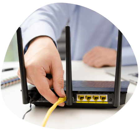 person plugging in their LAN cable