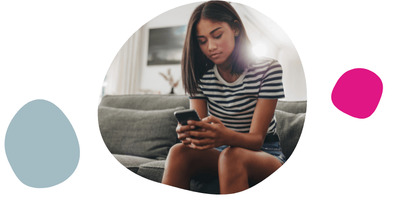 young woman using her phone at home