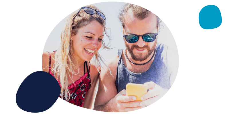 couple using their mobile on holiday