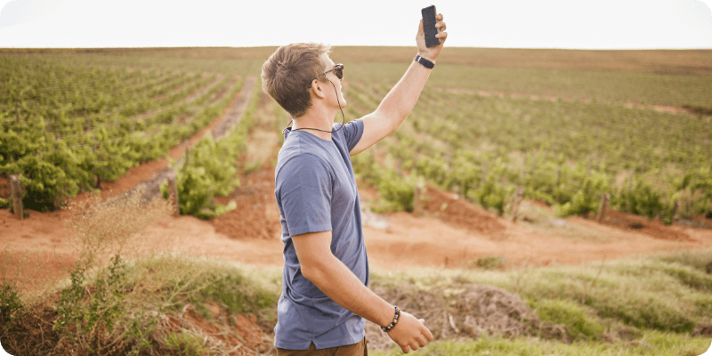 man trying to get signal from his mobile