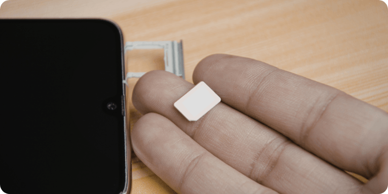 person replacing their SIM card